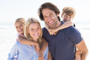 family on the beach benefits from Family Therapy