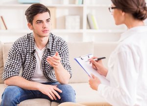 young man undergoes Psychotherapy with therapist