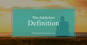 man contemplating addiction definition on beach
