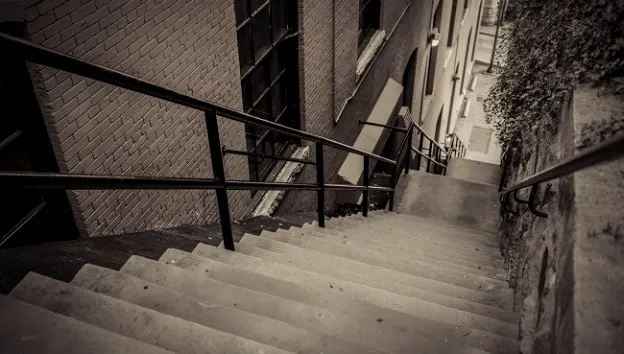 A narrow outdoor concrete staircase.