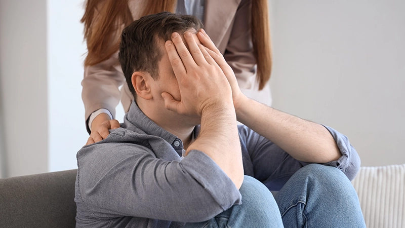 Upset male drug addict visiting psychologist in office.