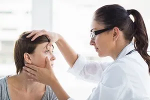 Doctor examining a patient's eyes during a medical checkup.