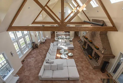 Modern living room with vaulted ceilings and wooden beams.