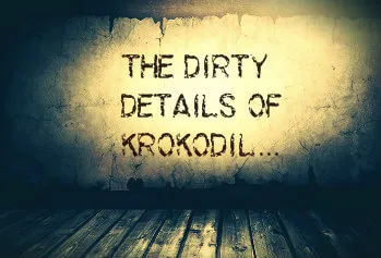 A dark, gritty room with a weathered wall and wooden floorboards.