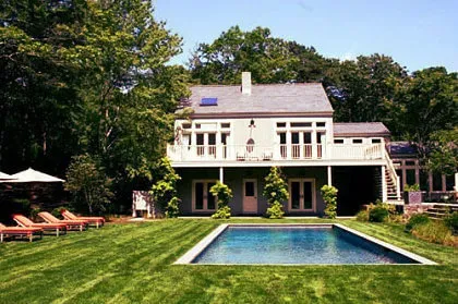 Gemini said A large two-story house with a balcony, pool, and lawn.